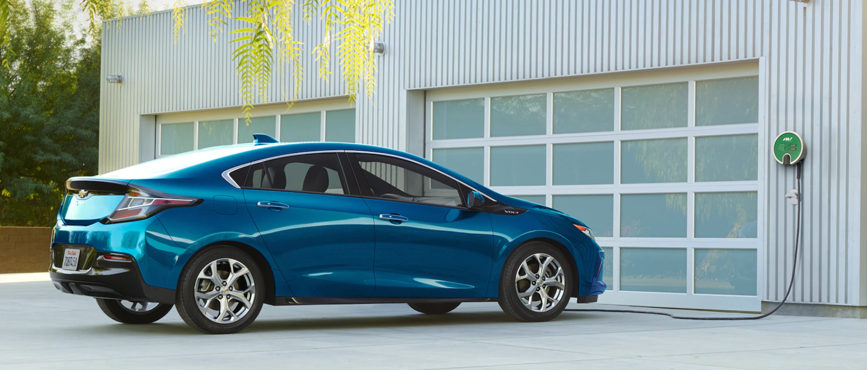 Blue 2019 Chevy Volt connected to wall charger