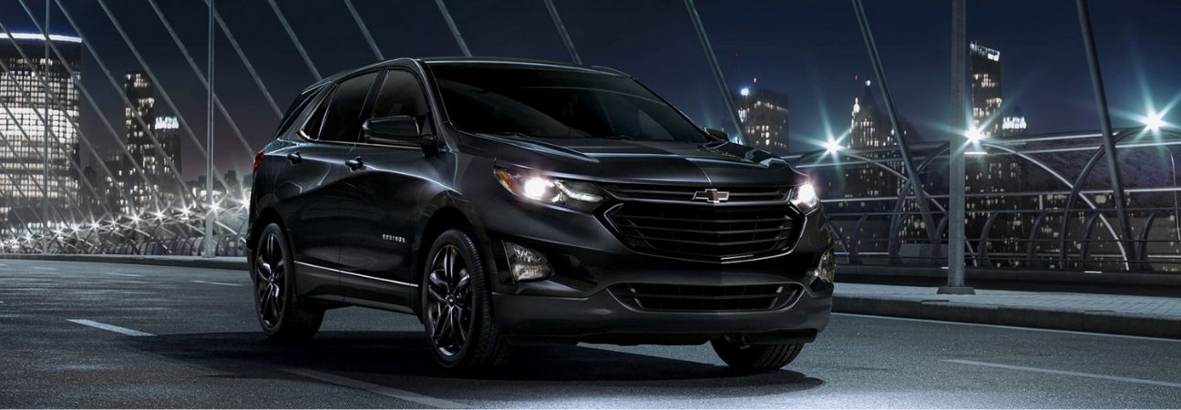 2020 chevrolet equinox driving through the city at night